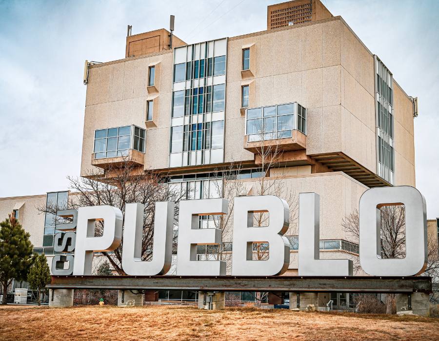 Photo of CSU Pueblo Sign with Library in background